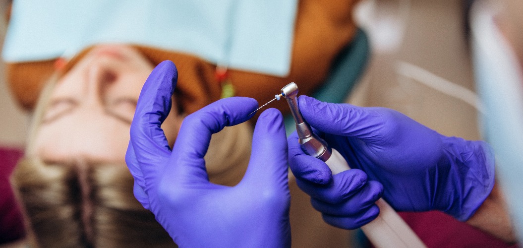 Closeup picture of dental instruments: drill and needle for root canal treatment and pulpitis in hand at the dentist